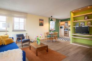 a living room with a blue couch and a table at Hotel Nieuw Antiek in Helden
