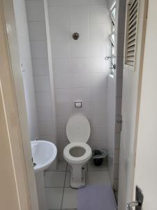 a small bathroom with a toilet and a sink at Vicz Palace Hotel in Curitiba