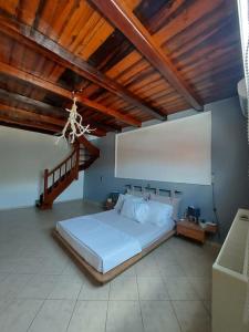 a bedroom with a large bed and a wooden ceiling at Dimitra's Villa in Evia, Greece in Loukísia