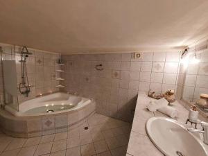 a bathroom with a tub and a sink at Dimitra's Villa in Evia, Greece in Loukísia