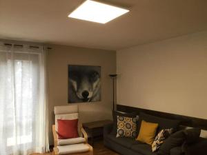 a living room with a couch and a painting of a wolf at Appartamento Mountain Paradise Ponte di Legno Tonale in Ponte di Legno