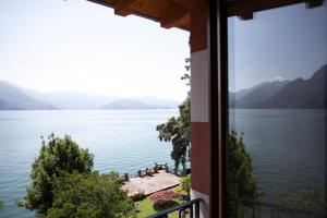 a view of a lake from a window at IseoLakeRental - Casa del Pescatore in Riva di Solto