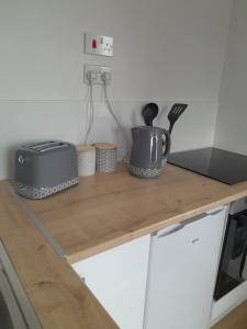 a counter with a microwave and a toaster on it at Lealt Falls Apartment in Culnacnoc