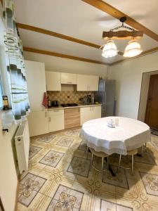 a kitchen with a table in the middle of a room at Villa “Eleon” in Velyka Bihanʼ