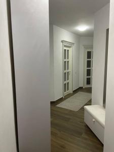 an empty room with white walls and wooden floors at Lovely 1 bedroom apartment with parking in Iaşi