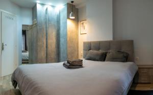 a bedroom with a large white bed with towels on it at Alexandros in Thessaloniki