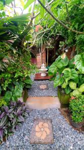 un jardín con un banco y un montón de plantas en Your Secret Garden Villa - Melasti Beach! en Ungasan