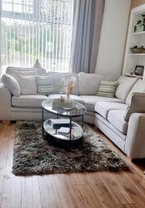 a living room with a couch and a table at Churchview in Townhill