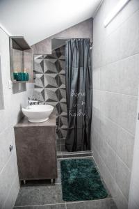 a bathroom with a sink and a shower at Happy in Pirot