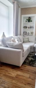 a white couch sitting in a living room at Churchview in Townhill