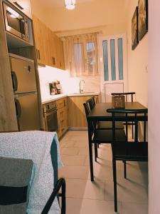 a small kitchen with a table and chairs in it at Home in the heart of city in Athens