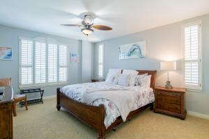 a bedroom with a bed and a ceiling fan at Beach Colony West Penthouse 2A By Pkrm in Pensacola +33 photos