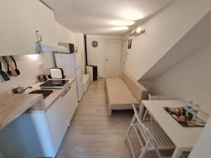 a room with a kitchen and a room with a staircase at Al Castello - Aeroporto delle Marche - Ancona in Falconara Marittima