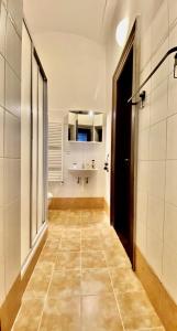 a hallway of a bathroom with a sink and a toilet at Spacious cozy apartments in centre in Prague