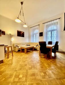 a living room with a table and a couch at Spacious cozy apartments in centre in Prague