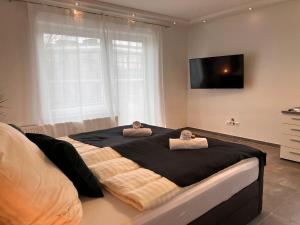 a bedroom with a large bed with two pillows on it at LUX Business Apartments in Weil am Rhein