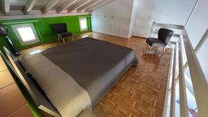 a large bed in a room with two chairs at AsconaDolceVita in Ascona