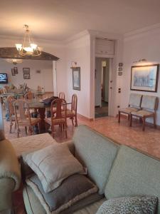 a living room with a couch and a dining room at شقة ايفو ترى المنتزه بالكامل in Alexandria