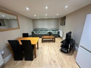 a living room with a couch and a table at HOMELY APARTMENT IN THE CENTRE in Boston