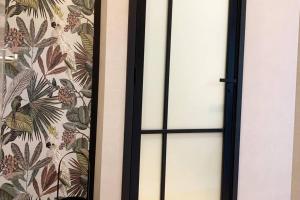 a sliding glass door with a floral wallpaper at Alkmaar center apartment close to station in Alkmaar