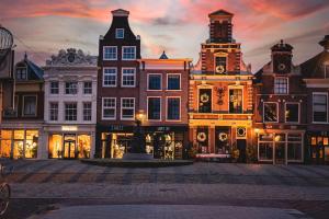 a group of buildings with a fountain in the middle at Alkmaar center apartment close to station in Alkmaar
