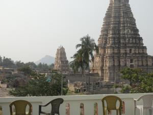 a group of chairs in front of a temple at Padmaa Hampi Villa in Hampi