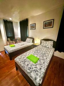 a hotel room with two beds and a table at West Side Cabana in Moalboal