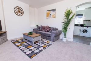a living room with a couch and a coffee table at Spacious-Comfortable-Free Parking-Garden in Nottingham