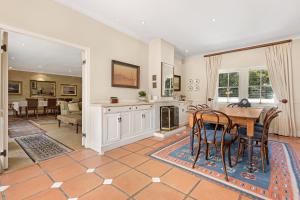a kitchen and dining room with a table and chairs at Leighwood Lodge in Johannesburg