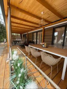 a wooden deck with a table and chairs at Eliška Holiday Home in Biograd na Moru