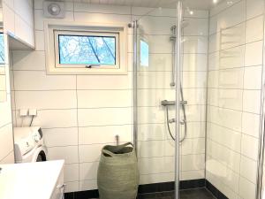 a bathroom with a shower and a sink and a window at Åre Travel - Villa & lilla Solbringen in Åre