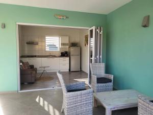 a living room with a table and chairs and a kitchen at Local Willibrord Lodge in Willibrordus