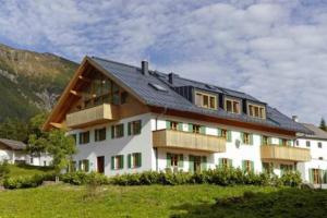 a large white building with a black roof at Chalet zur Rose in Berwang