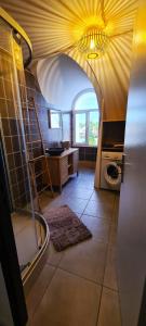 a bathroom with a sink and a washer and dryer at Emplacement d'exception in Filaos