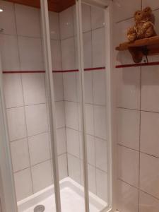 a bathroom with a shower with white tiled walls at Appartement exceptionnel à Valmorel in Valmorel