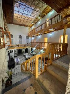 a large room with a staircase and a living room at Zaringiz Boutique in Bukhara