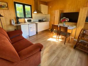 a living room with a couch and a table and a kitchen at Quinta Da Porta Caseira in Resende