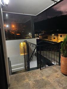 a balcony with a view of a city at night at Heinz B. in Santa Ana de los Caballeros