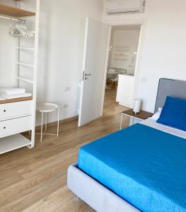 a bedroom with a bed and a desk and a chair at Via Firenze 11 in Follonica
