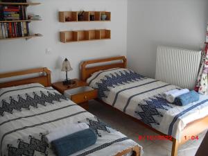 dos camas sentadas una al lado de la otra en un dormitorio en gemütliche Villa Mailin priv. Pool schöne Aussicht, en Skouloúfia