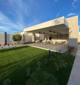 duży budynek z trawnikiem przed nim w obiekcie Beautiful new house with pool club w mieście Los Bledales