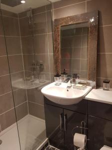 a bathroom with a sink and a shower at The Mews in Alderley Edge