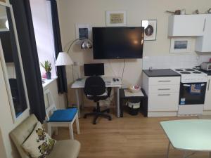 a small kitchen with a desk and a computer in it at HAVEN STUDIO GROUND FLOOR in Whitehaven