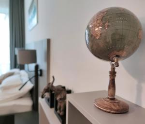a globe on a table in a bedroom at Spa Residence Carbona Silver Deluxe Apartment in Hévíz +23 photos