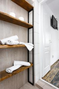 a room with wooden shelves and towels on a wall at Caraiman Hive in Buşteni