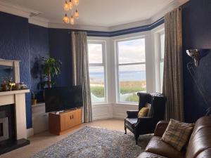 a living room with a large window and a television at Loughview in Bangor
