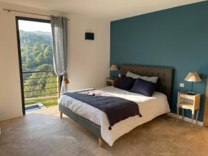 a bedroom with a bed and a large window at AQUARIUS IN CASSIS, Chambres d'Hôtes in Cassis