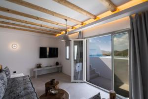 a living room with a view of the ocean at Mykonos Village in Ano Mera