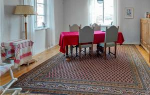 a dining room with a red table and chairs at Lovely Home In Fridlevstad With Wifi in Fridlevstad