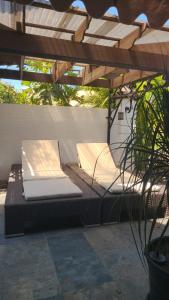 two beds under a pergola on a patio at Caribbean Estates, 10 mins from the Beach, Beautiful Gated Community in Portmore